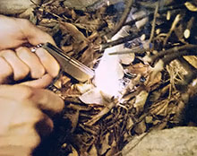Step five: Strike sparks from the flint side you your magnesium block until the slivers of magnesium catch.